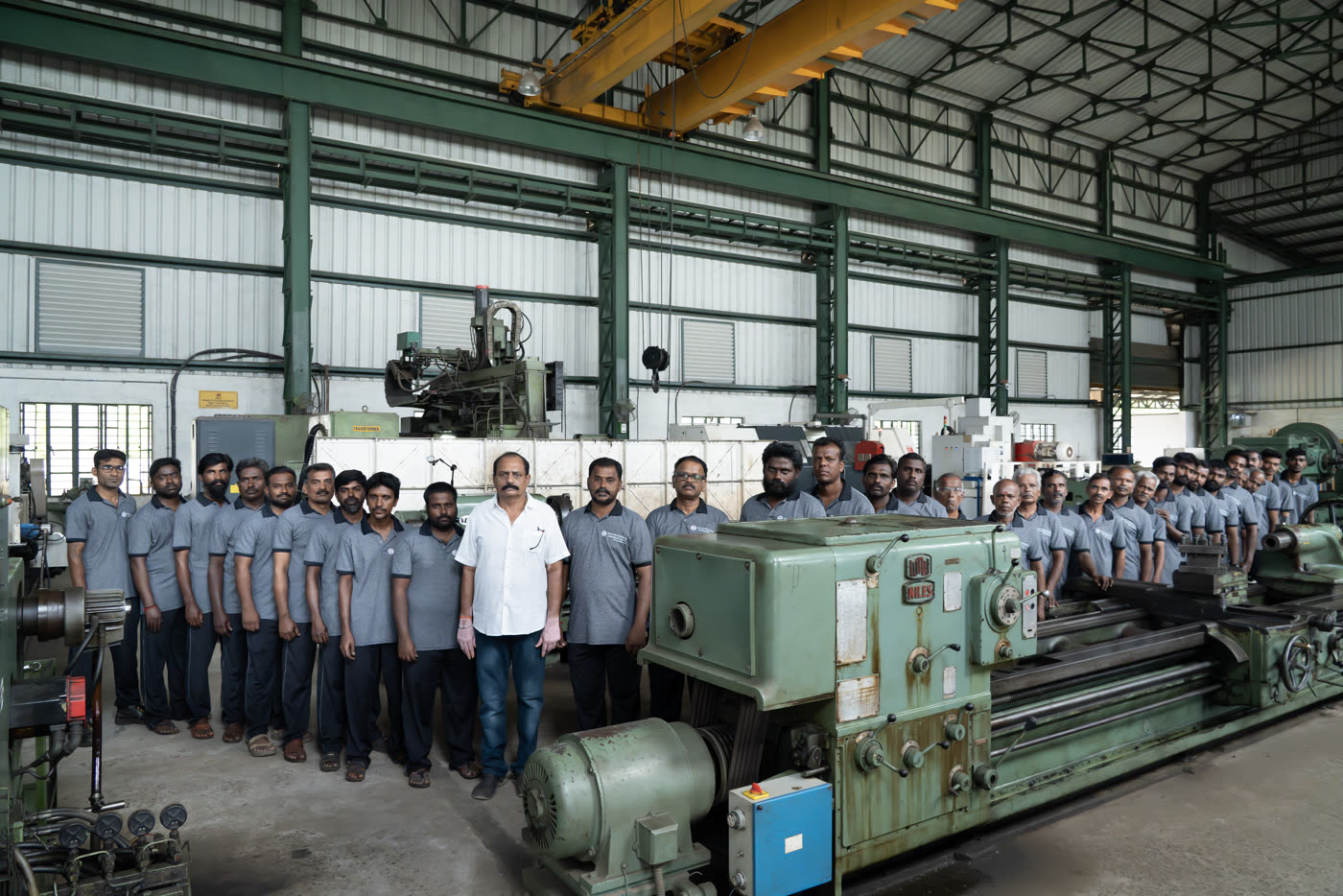 The team on the shop floor, alongside heavy machinery